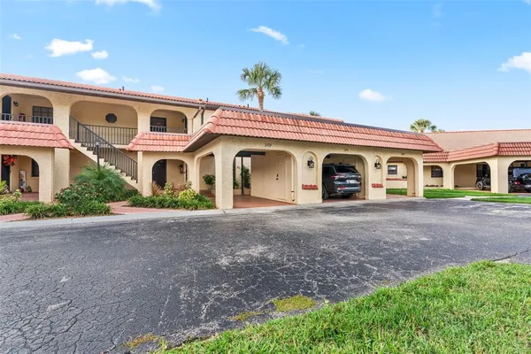 a kitchen with granite countertop a refrigerator stove and sink