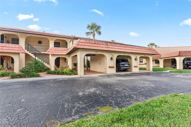 a kitchen with granite countertop a refrigerator stove and sink