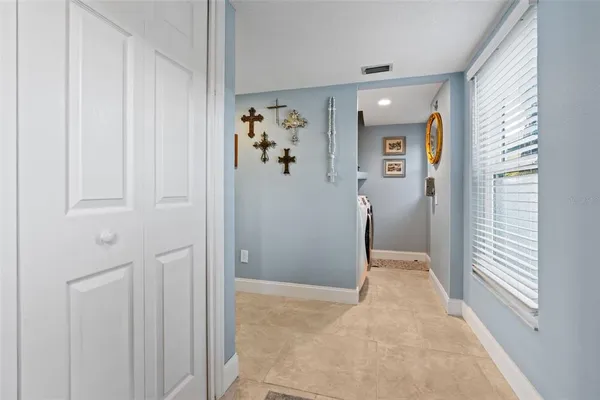 a living room with furniture a couch and a potted plant