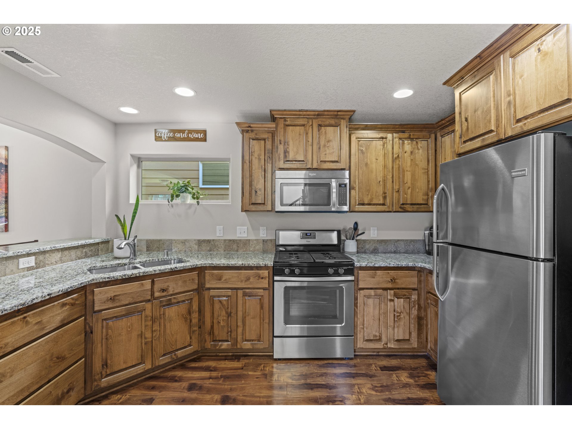 113 Northwest 76th Street Vancouver, WA 98665 - Photo 11 of 33 a kitchen with stainless steel appliances granite countertop a refrigerator a stove a sink and a microwave
