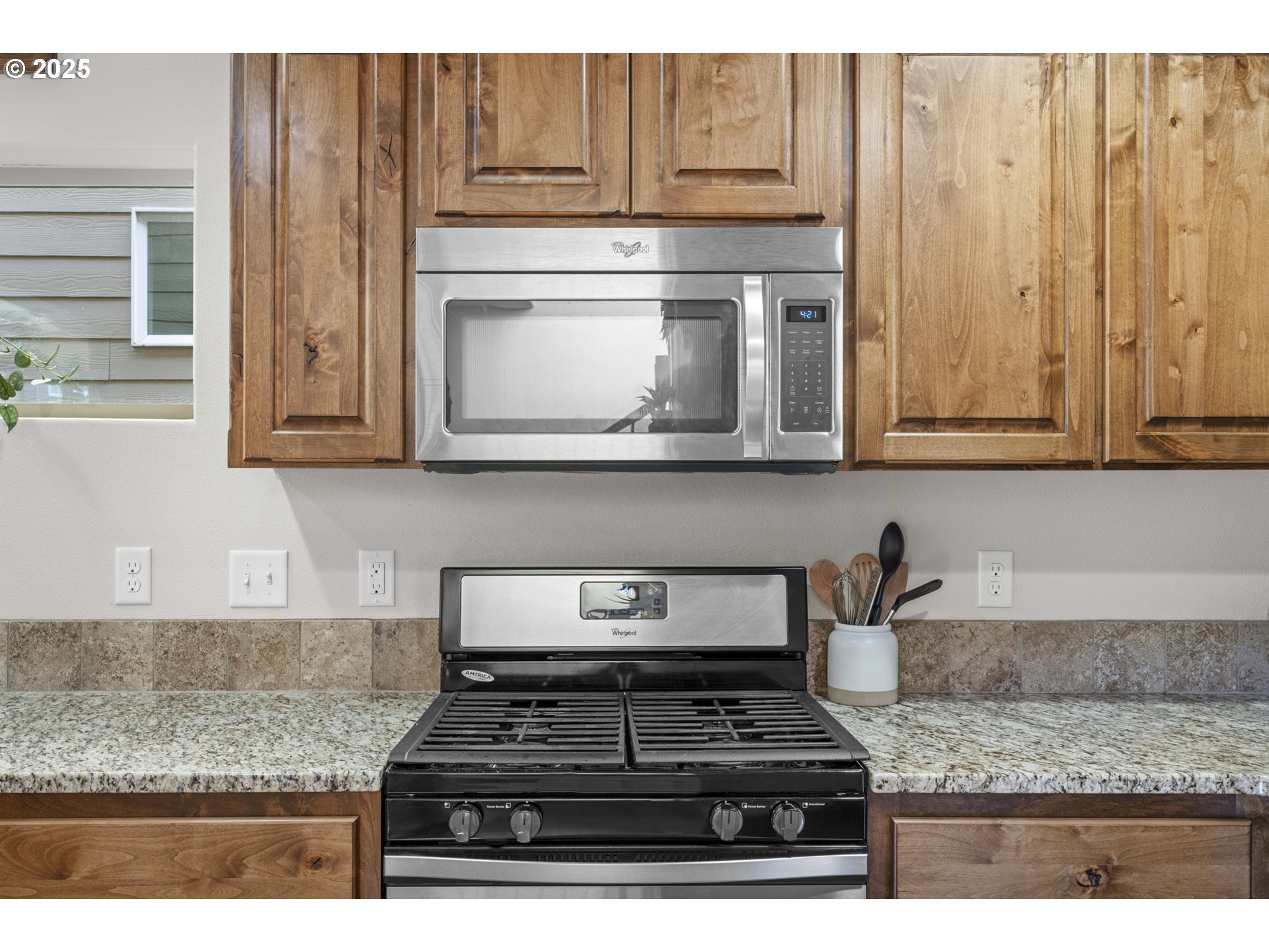 113 Northwest 76th Street Vancouver, WA 98665 - Photo 13 of 33 a kitchen with granite countertop cabinets stove top oven and microwave