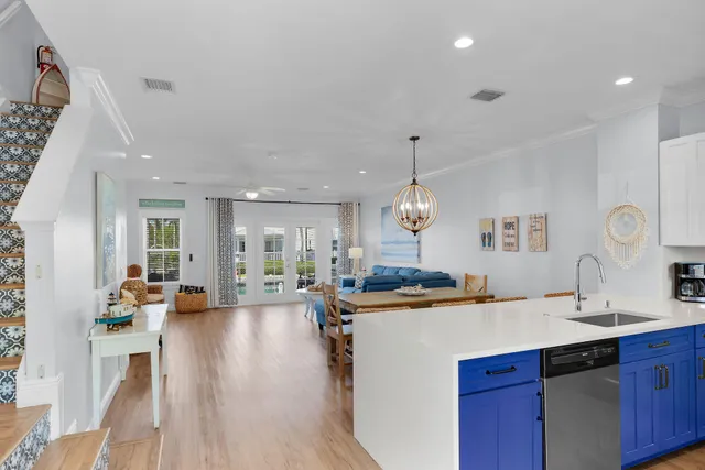 a large kitchen with sink a counter top space and living room view