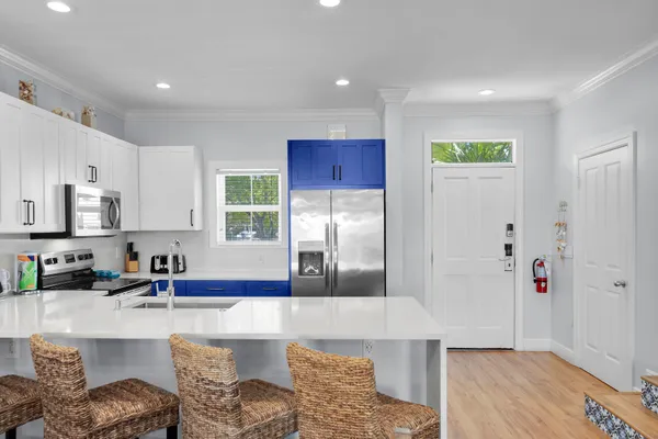 a kitchen with granite countertop a refrigerator and a sink