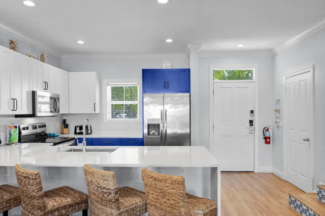 a kitchen with granite countertop a refrigerator and a sink
