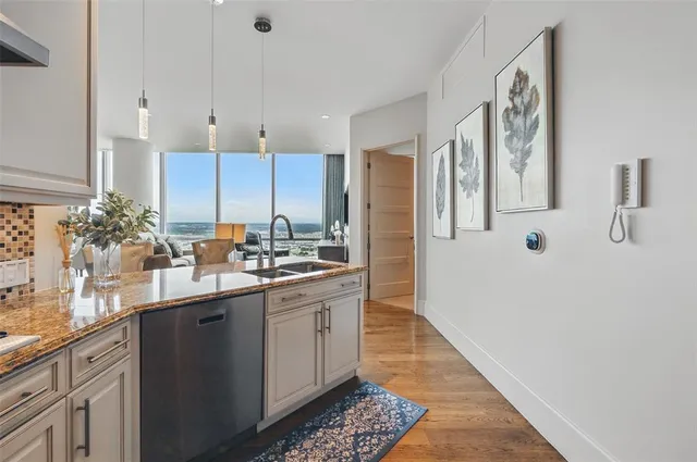a spacious bedroom with a large bed and a chandelier