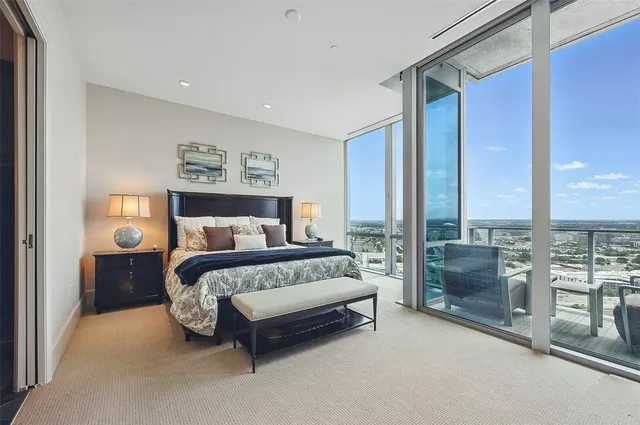 a large bedroom with a large bed and a large window