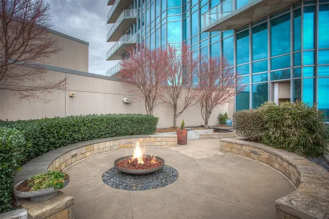 a kitchen with granite countertop kitchen island stainless steel appliances a sink and living room view