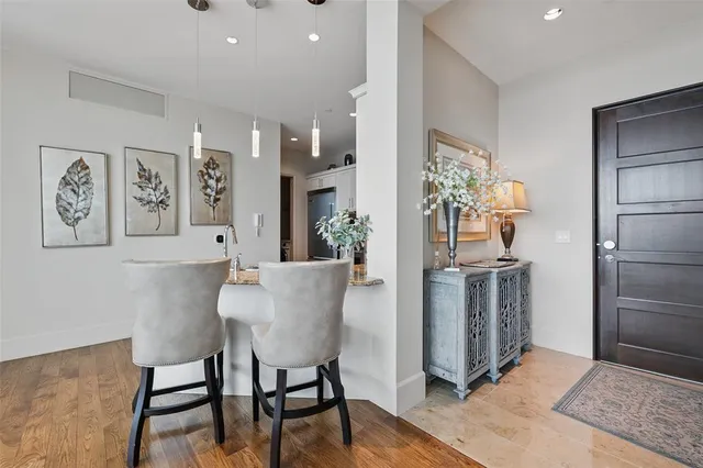 a dining room with kitchen island a table and chairs