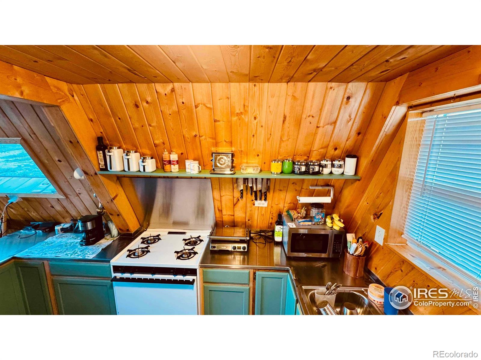 867 Windy Ridge Road Livermore, CO 80536 - Photo 9 of 23 a kitchen view with a sink and wooden floor