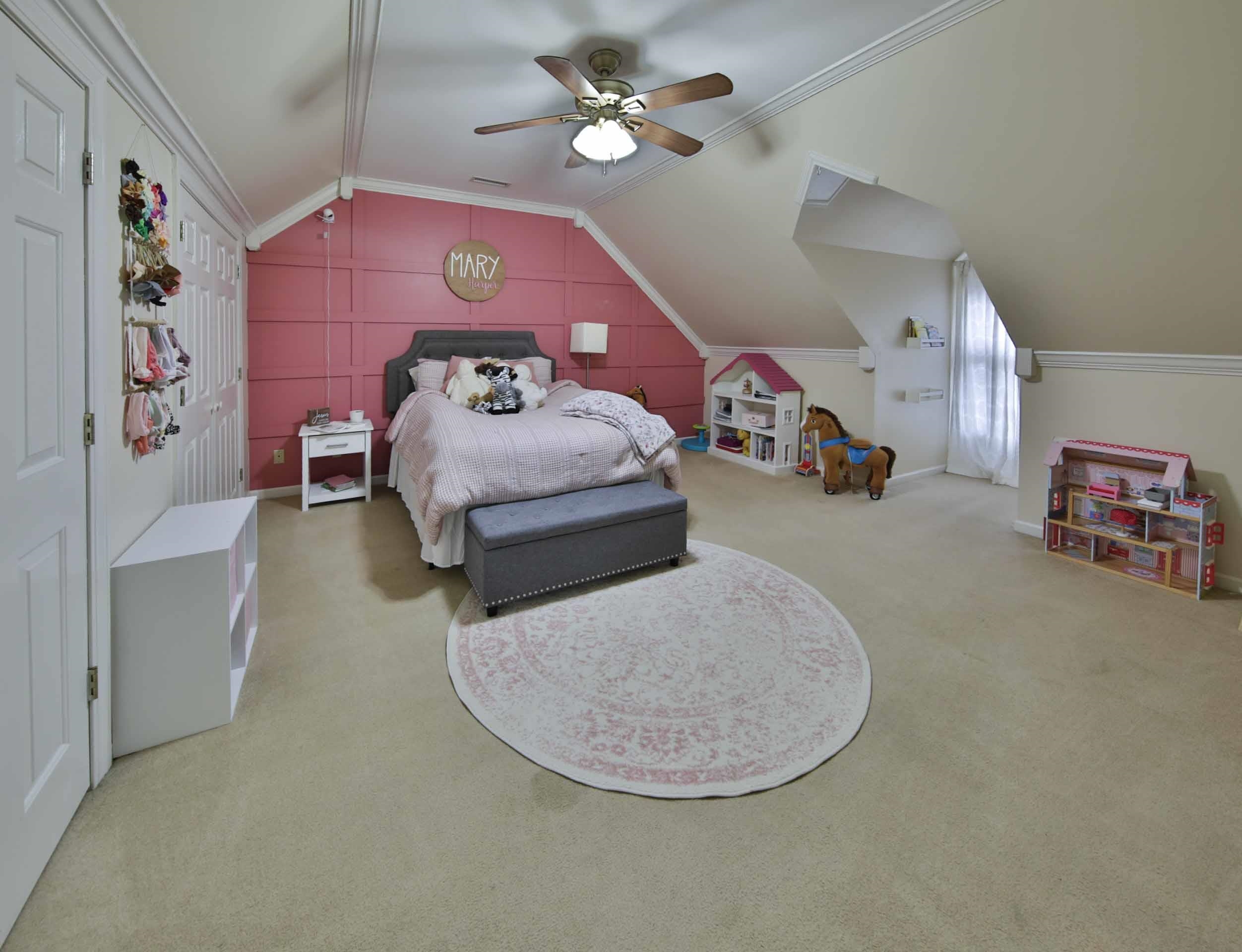 104 Miller Road Covington, TN 38019 - Photo 21 of 25 Room featuring a sloped ceiling, wall-mounted trim detailing, a ceiling fan with integrated lighting, and neutral carpeting