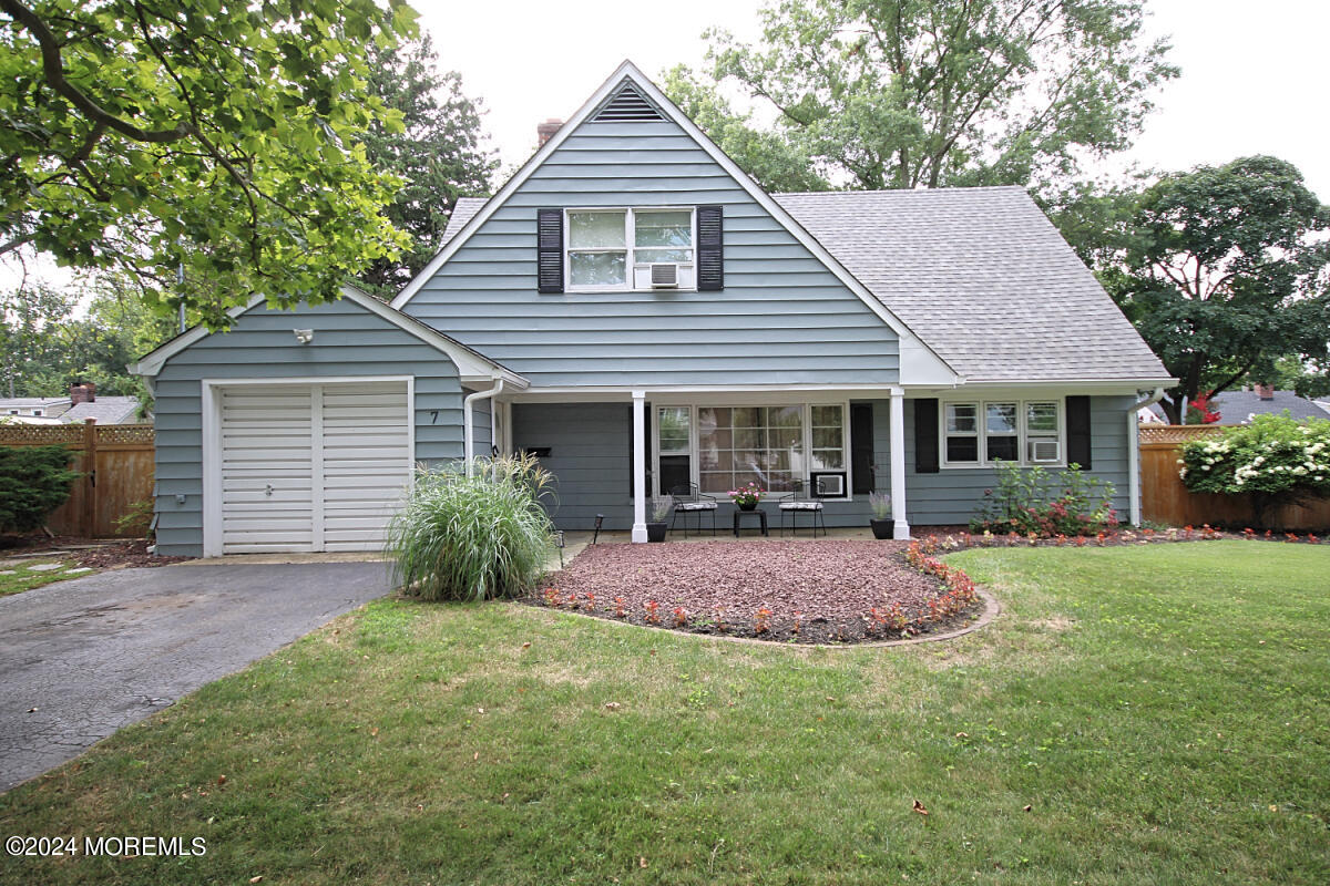 a front view of a house with yard and porch
