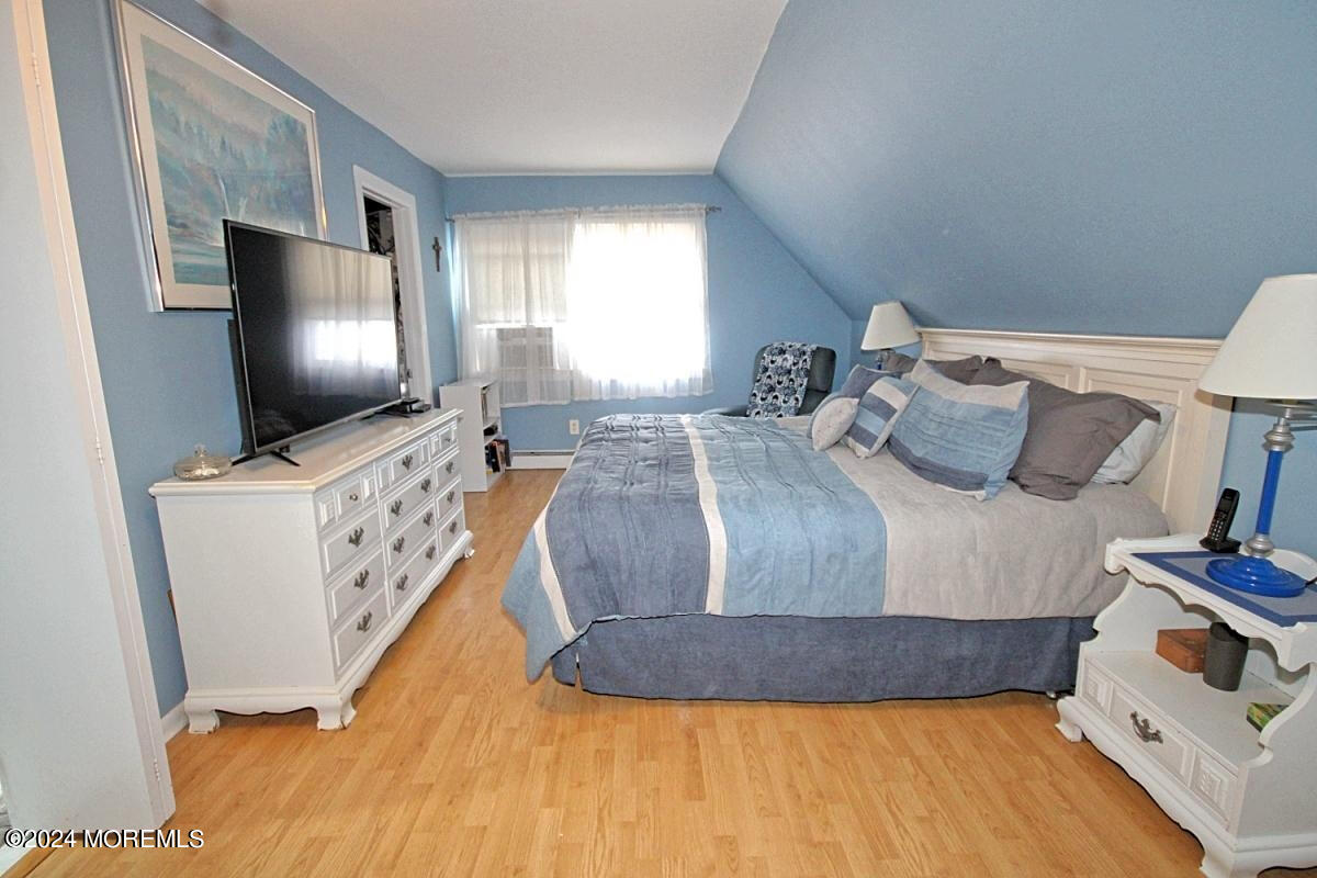 7 Taylor Road Matawan, NJ 07747 - Photo 12 of 33 a bedroom with a bed and flat screen tv