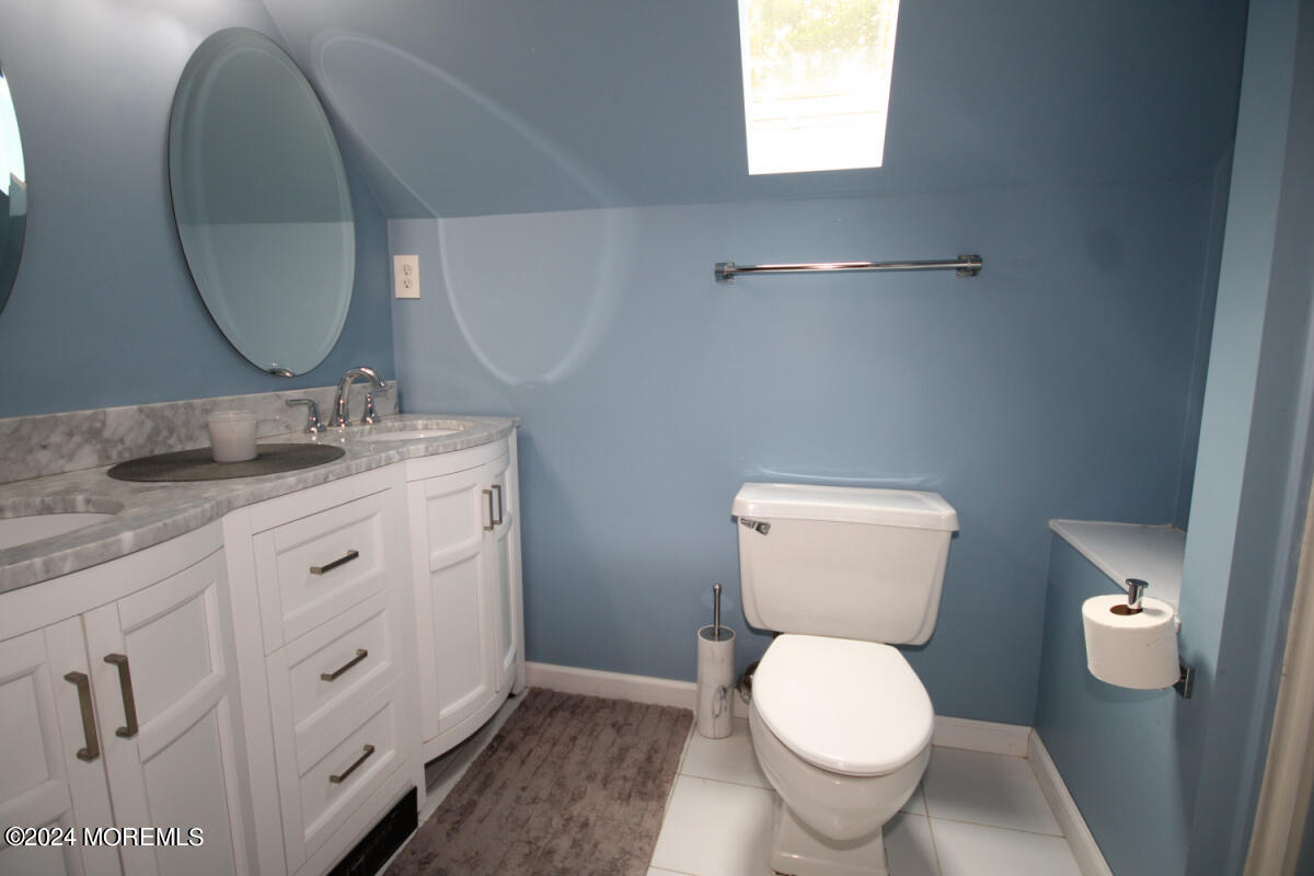 7 Taylor Road Matawan, NJ 07747 - Photo 13 of 33 a bathroom with a toilet sink and mirror