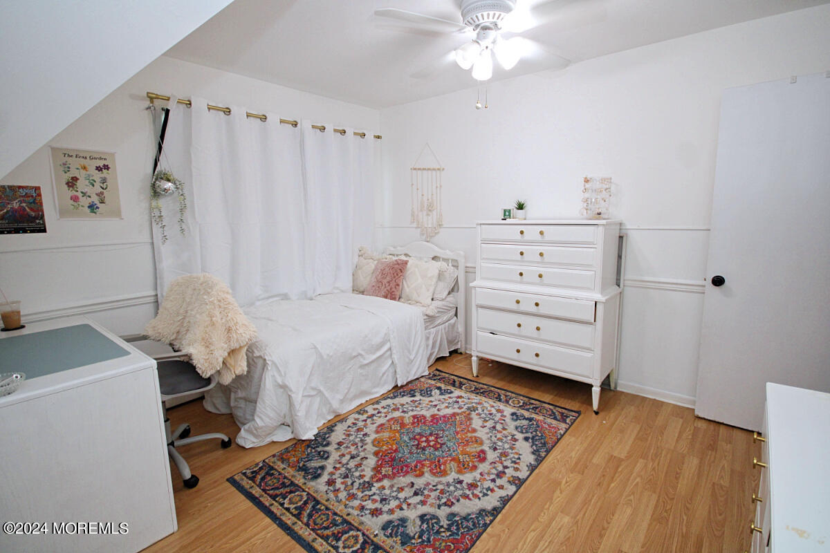 7 Taylor Road Matawan, NJ 07747 - Photo 16 of 33 a bed room with a bed and a chair