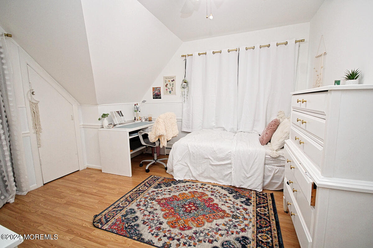 7 Taylor Road Matawan, NJ 07747 - Photo 17 of 33 a bedroom with a bed and a chandelier