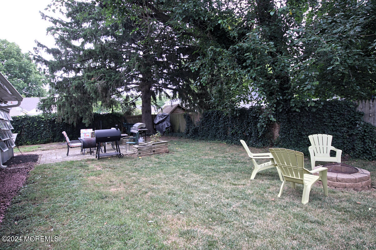 7 Taylor Road Matawan, NJ 07747 - Photo 22 of 33 a wooden bench sitting in the middle of a yard