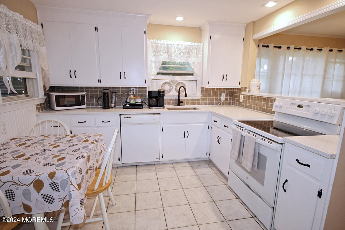 7 Taylor Road Matawan, NJ 07747 - Photo 6 of 33 a large white kitchen with a sink a window and stainless steel appliances