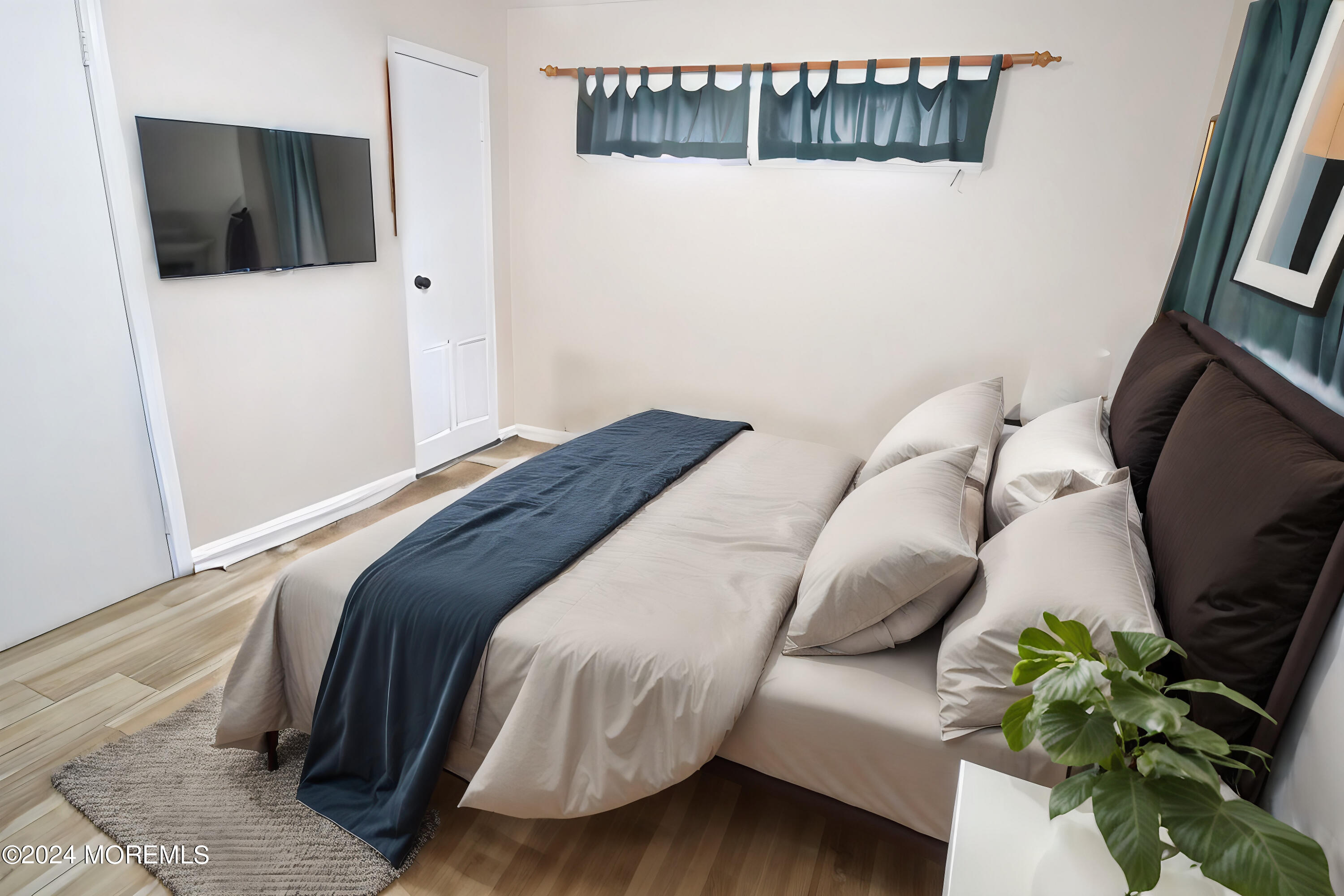 7 Taylor Road Matawan, NJ 07747 - Photo 10 of 33 a bedroom with a bed and a potted plant