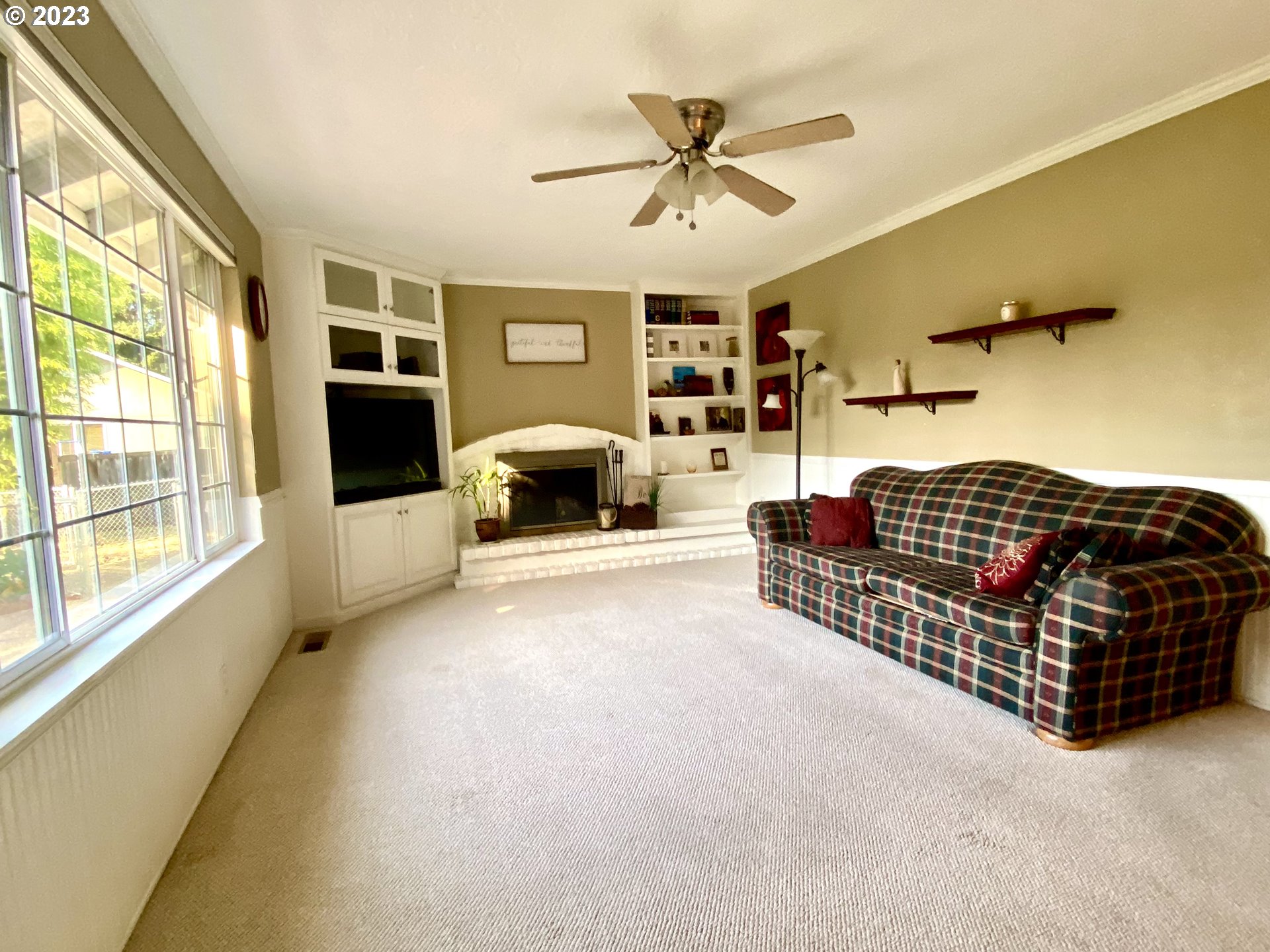 6566 E Street Springfield, OR 97478 - Photo 26 of 46 a living room with furniture a fireplace and a large window