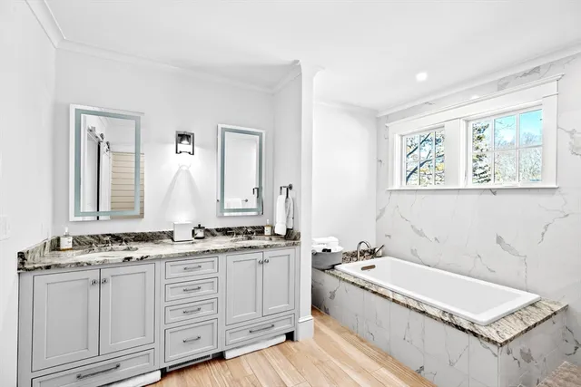 a spacious bathroom with a granite countertop tub sink and mirror