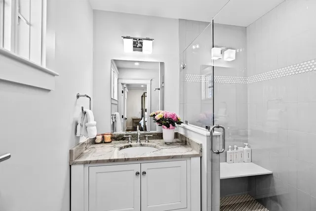 a bathroom with a double vanity sink and a mirror