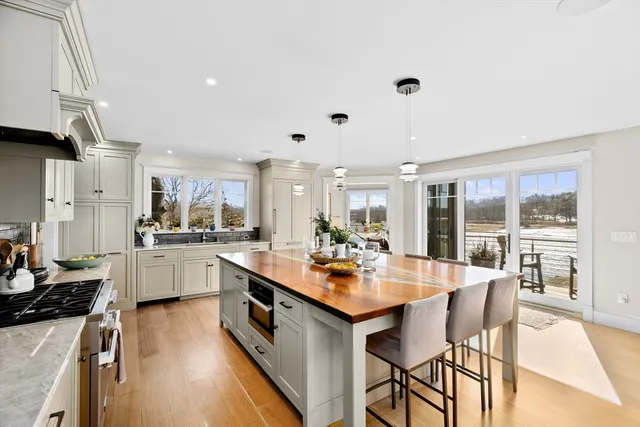 a large kitchen with kitchen island a large island in the center
