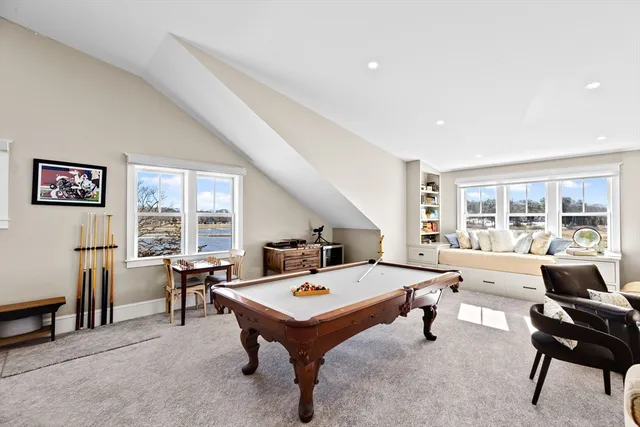 a living room with furniture a rug and a large window