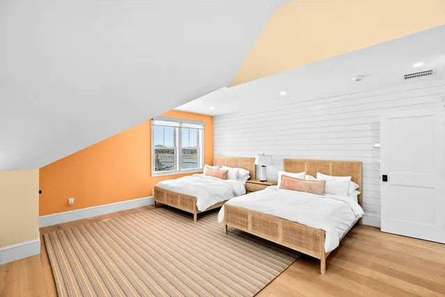 a bedroom with two beds and a large window