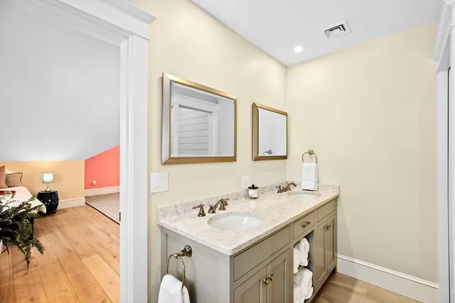 a bathroom with a sink vanity and a mirror