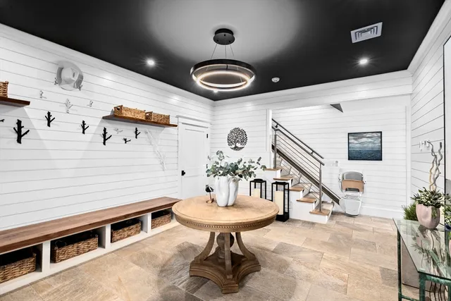 a living room with furniture and a chandelier