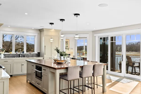 a large white kitchen with a large window