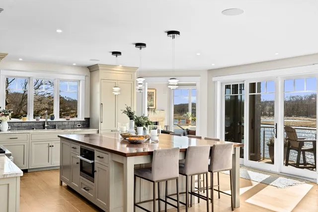 a large white kitchen with a large window