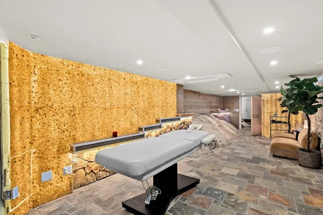 a living room with furniture pool table and a flat screen tv