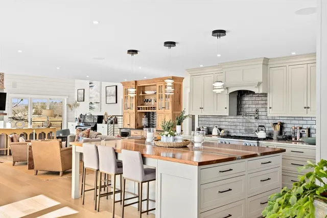 a kitchen with granite countertop white cabinets and chairs