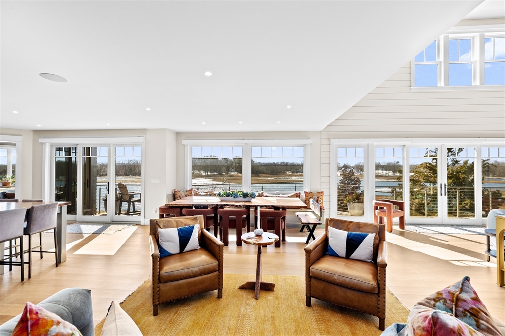 67 Border Street Scituate, MA 02066 - Photo 9 of 42 a living room with furniture large windows and wooden floor