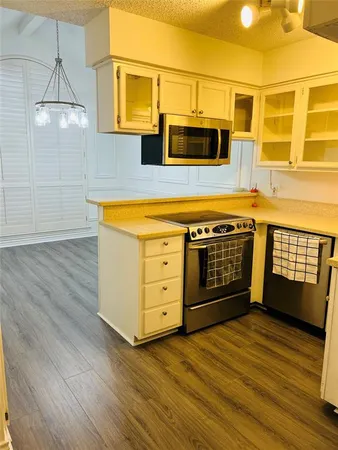 a view of a kitchen with a sink and microwave