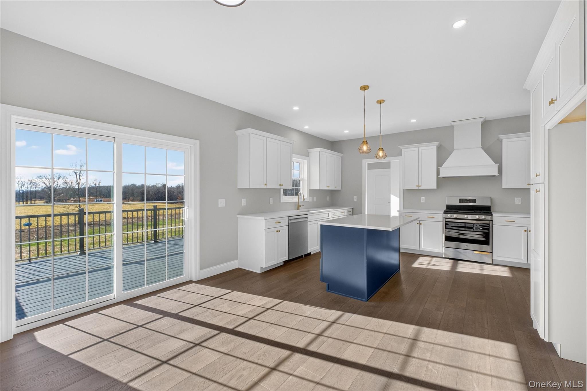 Lot 4 Kings Hill Road Walden, NY 12586 - Photo 9 of 34 a large kitchen with kitchen island granite countertop a stove a sink dishwasher a dining table and cabinets
