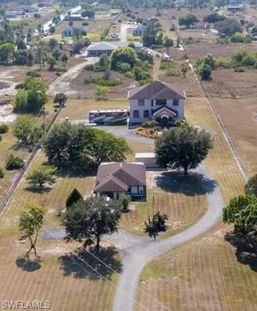 an aerial view of a house with yard swimming pool and outdoor seating