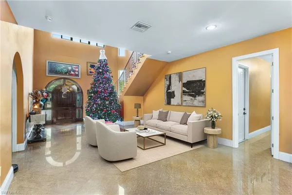 a living room with furniture and flowers