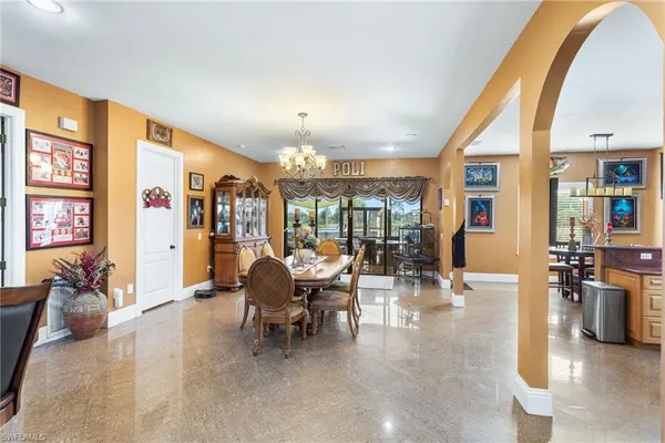 a living room with furniture and large windows