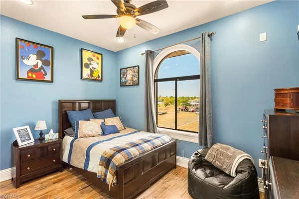 a bedroom with a bed and a chandelier
