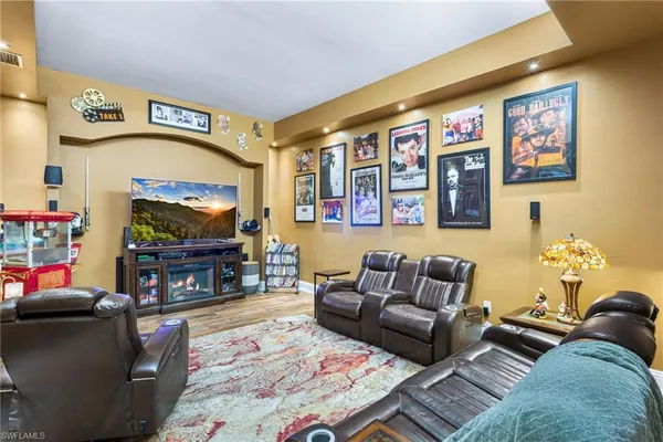 a living room with fireplace furniture and a flat screen tv