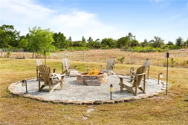 a view of a lake with a table and chairs