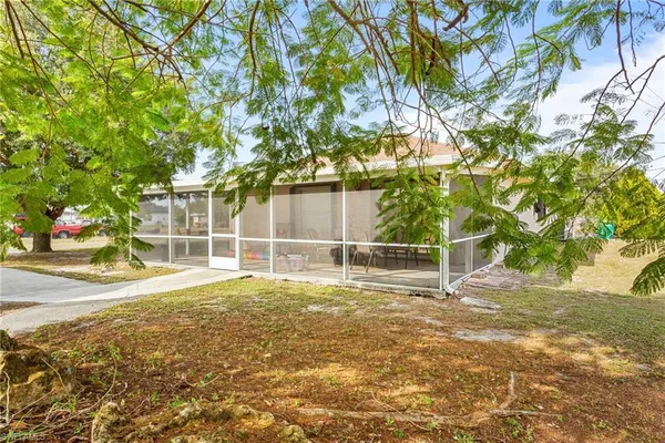 a view of empty room with wooden floor and fence