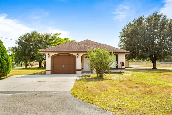 a view of a house with pool and a yard