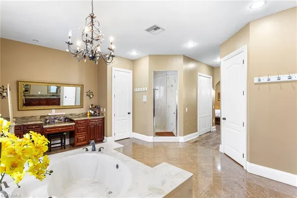 a spacious bathroom with a tub shower and a sink