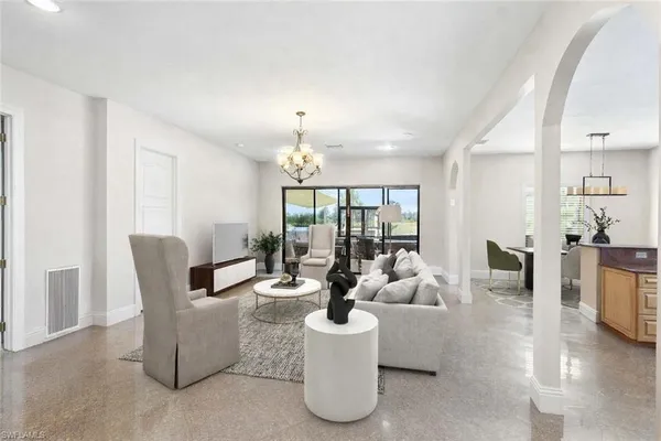 a living room with furniture and a chandelier