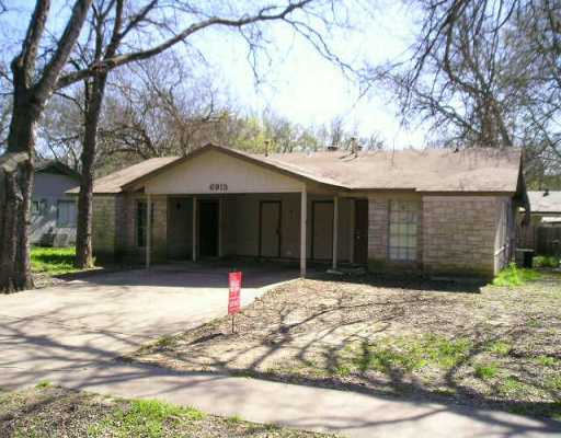 6913 South Pleasant Valley Road Austin, TX 78744 - Photo 1 of 1 a front view of a house with a yard covered in snow