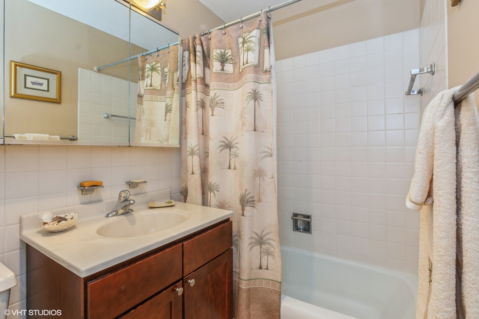 655 West Irving Park Road, Unit 4617 Chicago, IL 60613 - Photo 11 of 33 a bathroom with a sink a mirror and a shower