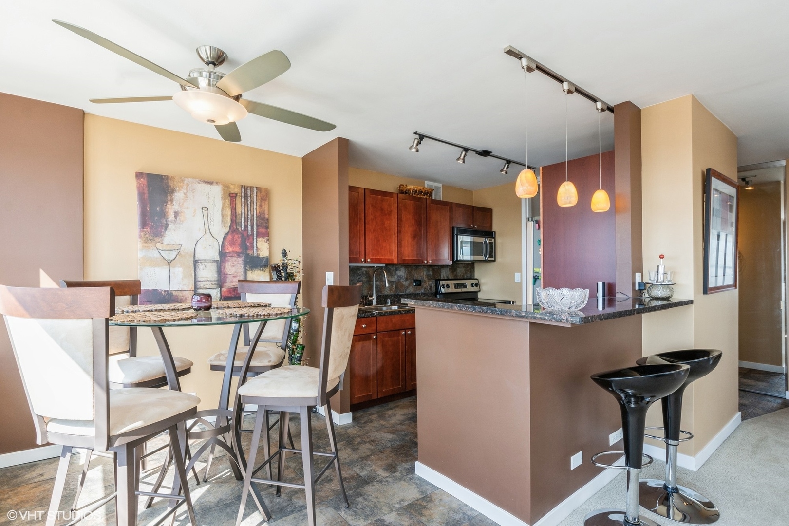 655 West Irving Park Road, Unit 4617 Chicago, IL 60613 - Photo 7 of 33 a kitchen with a table chairs refrigerator and cabinets